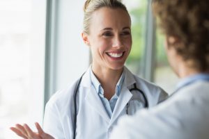 Beautiful doctor discussing with colleague in a promotional video.